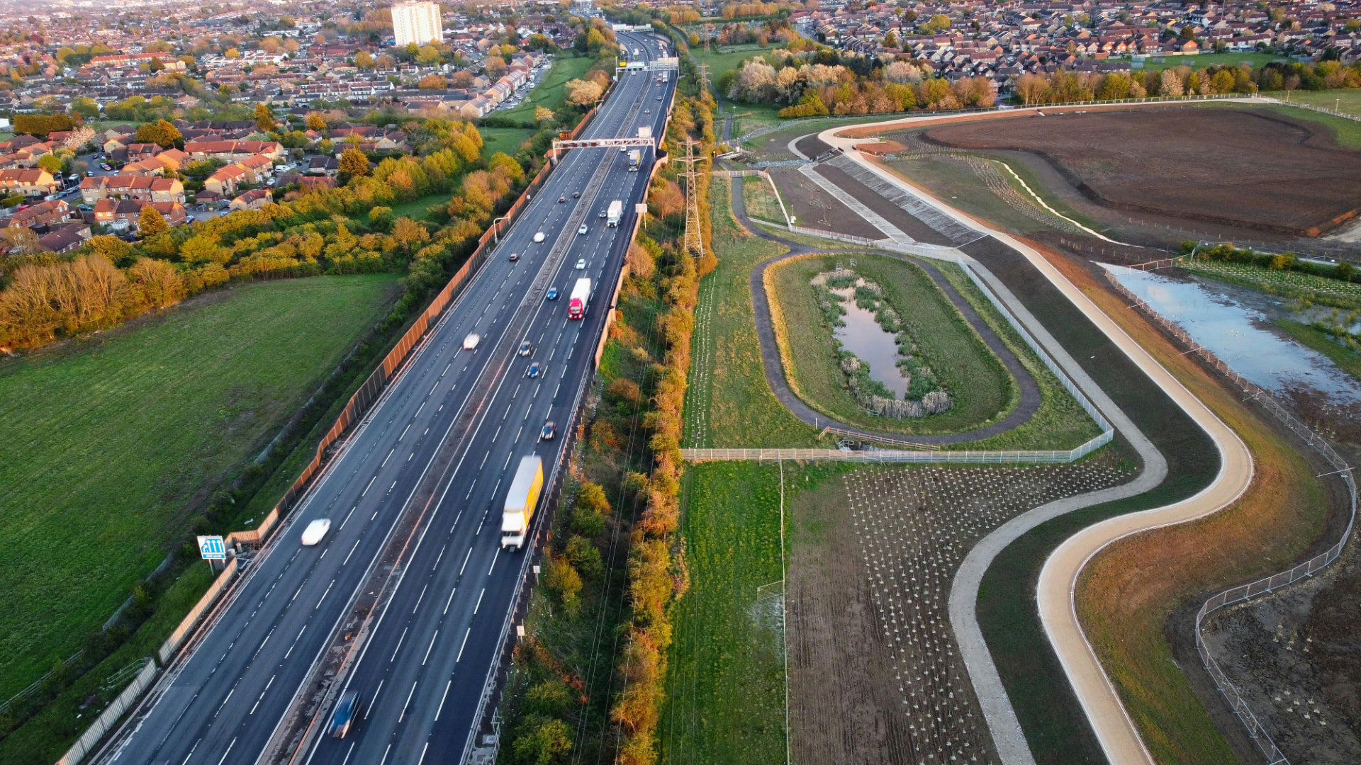 Aerial view of the M1 motorway beside housing